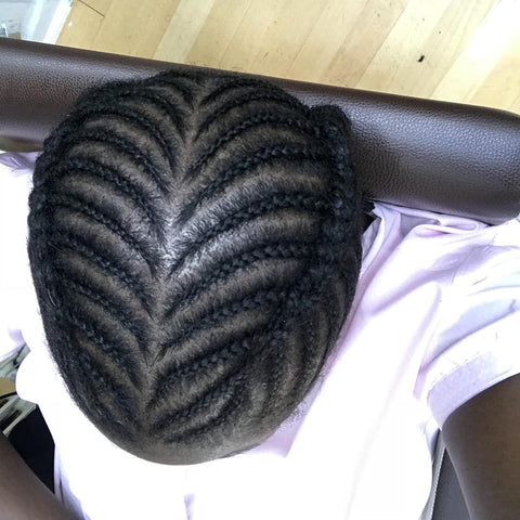 overhead view of a fishbone cornrow hairstyle